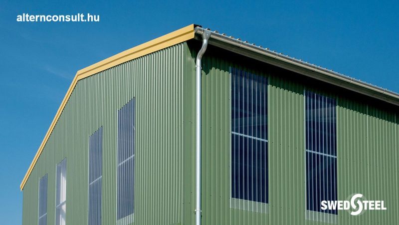 Hobol. Crop storage and processing plant with Swedsteel girder and anti-condensation trapezoidal sheet. Z150 and Z200 roof racks, C120 beam racks, STR45 / 0.5 roof trapezoidal sheet PE25 coated + anti-condensation felt layer, STW20 / 0,5 wall trapezoidal plate with PE25 coating and SBV20PC light strips.
